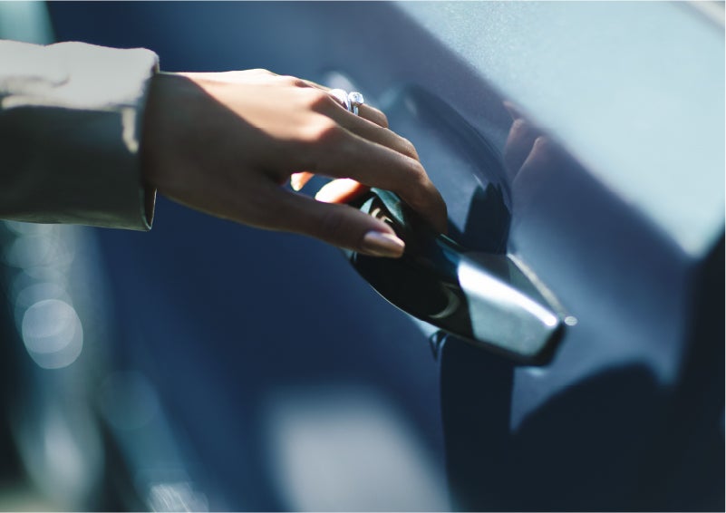 A hand gracefully grips the Light Touch Handle of a 2023 Lincoln Aviator® SUV to demonstrate its ease of use | Capital Lincoln of Wilmington in Wilmington NC